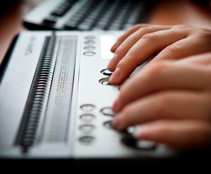 Person Using Electronic Braille Display